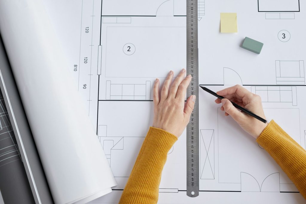 Woman Drawing Floor Plans Top View
